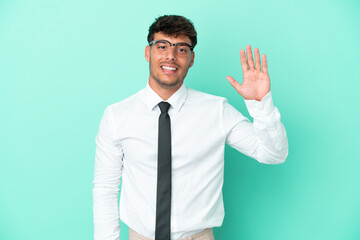 Business caucasian man isolated on blue background saluting with hand with happy expression