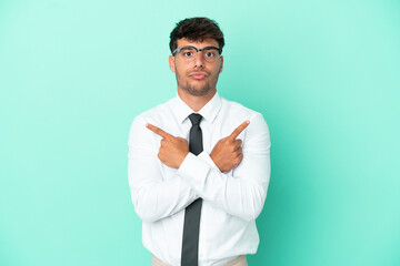 Business caucasian man isolated on blue background pointing to the laterals having doubts