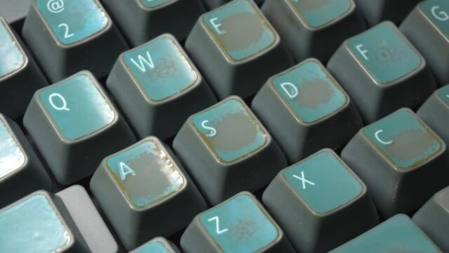 WASD keys on a vintage old faded worn mechanical desktop PC keyboard, letters, object detail, closeup, slow zoom in. Retro computing, video game controls, electronic input device concept, nobody