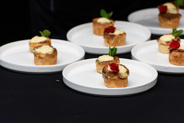 Typical Portuguese custard pies Pastel de Nata or Pastel de Belem. traditional portuguese pastry. On a black tablecloth