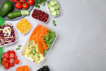 Set of plastic containers with fresh food on light table, flat lay. Space for text