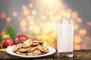 Fresh traditional christmas milk with cookies on Christmas lights background,