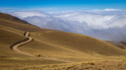 clouds over the mountains and road
