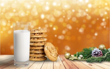 Fresh traditional christmas milk with cookies on Christmas lights background,