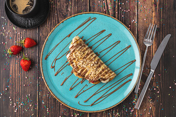 sandwich waffles with banana, strawberry and chocolate and pistachio on top