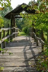 Old wooden bridge with roof in the middle