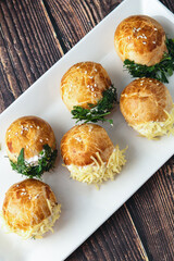 Turkish pastry filled with dill, parsley, cream cheese and cheddar cheese. Turkish name: Sakallı Pogaca or Saçaklı Pogaca