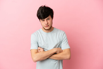 Young Russian man isolated on pink background feeling upset