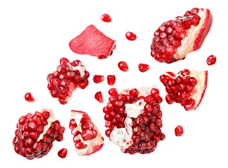 Pomegranate fruit pieces and grains falling on a white background, cut. Isolated
