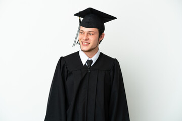 Young university Russian graduate isolated on white background looking to the side and smiling