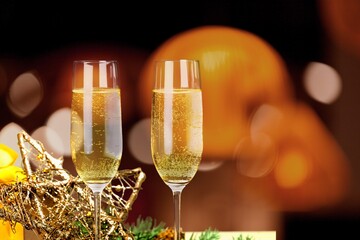 Two glasses of champagne with glitter light on background, new year 2022o