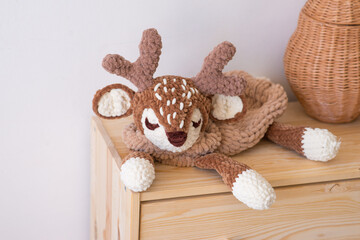 soft knitted toy deer. Christmas deer. Soft knitted toy deer