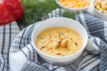 pea cream soup with fried crispy crackers, herbs and spices,vegetables,textiles,selective focus