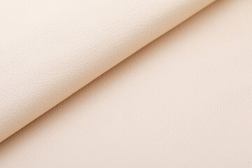 light beige ivory folded natural cow leather on the wooden table	