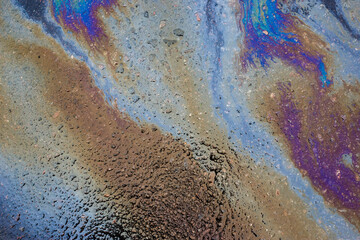 Beautiful abstract stain of motor oil, gas or petrol spilled on the asphalt