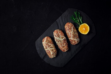 Traditional Cypriot Seftalia dish, raw, top view, on a black background, no people,