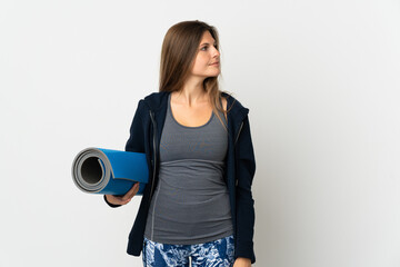 Slovak girl going to yoga classes isolated on white background looking to the side