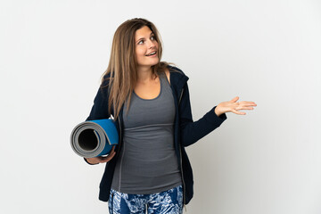 Slovak girl going to yoga classes isolated on white background with surprise expression while...