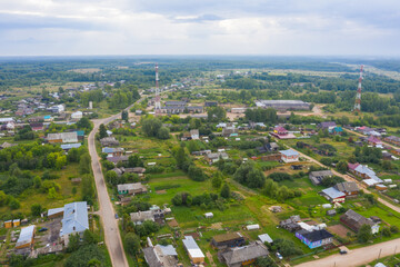 Fototapeta na wymiar Aerial view from a drone of a rural village in the Kirov region, private houses and vegetable gardens in the village of Arbazh.