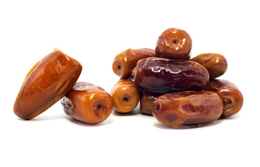 Dates isolate. Dates spill out from a cup in the shape of a heart on a white background close-up. Dried fruits