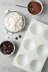 Ingredients for hot cocoa chocolate ball bomb with marshmallow. Holiday winter drink. Handmade Christmas present.
