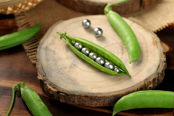Green Peas Pods with Pearl Inside on a Wooden Tray