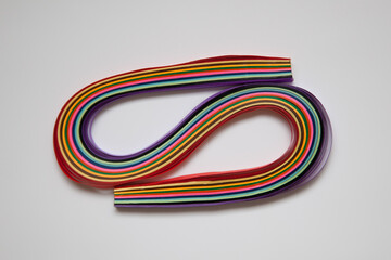 Rainbow colored quilling paper laid out in waves and shapes. Colourful Paper. A set of multi-colored paper stripes for creativity. © Tatiana Nurieva