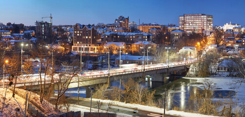 Naklejka premium Vinnytsia, Ukraine. Night winter city view from the river Southern Bug in the city of Vinnitsa to the central part in winter time. City center view