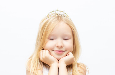 Funny little princess girl in silver crown and white dress over white background © Irina