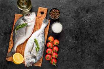 raw dorado fish on stone background with copy space for your text	
