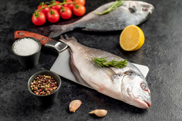 raw dorado fish on a knife on a stone background