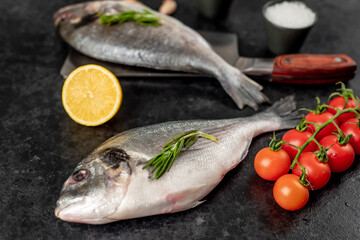 raw dorado fish on a knife on a stone background