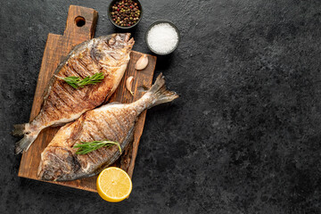 grilled dorado fish on stone background with copy space for your text