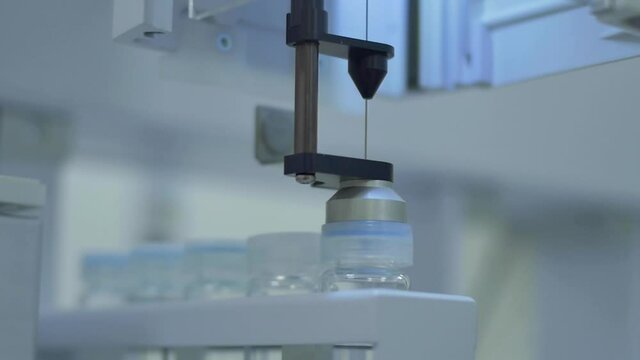 Slow motion close-up of working liquid spectroscopy machine at laboratory  