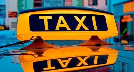 Lit taxi sign on roof of taxi car in the city