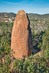 Sandstone menhir with mysterious inscribed symbols, dating from 6000-4500 BC, in the dry hills near...