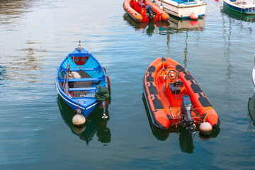 Blue Double Ender Boat and Orange Inflatable at Mooring
