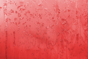 Red Ice background on a window with snowflakes.