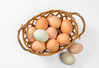 Fototapeta na wymiar natural colorful Eggs In The Basket On White Background
