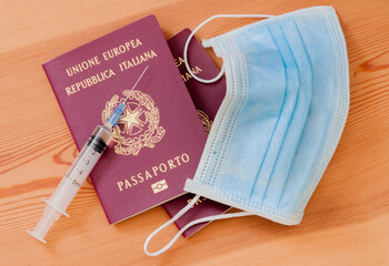 Italian passport, vaccine syringe, mask