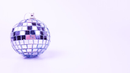 The Christmas tree toy in the form of a ball is decorated with a mirror . the color of the very peri on a white background. space for text