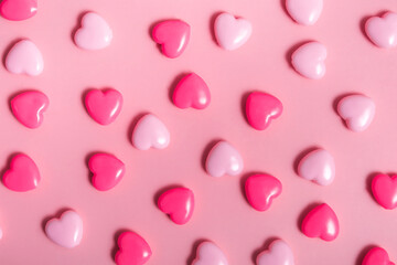 Composition for Valentine's Day on February 14. Pink background and colorful hearts, seamless pattern. Postcard, banner. Flat lay, top view. Closeup