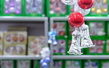 Glass Christmas bells with winter ornament and red christmas balls.