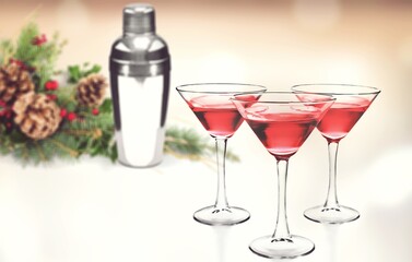 Winter alcoholic cocktail with berries, liquor for Christmas or New Year celebration. Holiday table setting