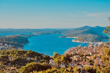 Panoramic view to the city and port of Mali Losinj. Island Losinj blue lagoon with Osorcica mountain in background. Adriatic Sea.Buildings and houses.