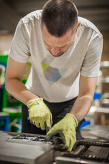 Technician making fridge magnet with soft PVC rubber in mold