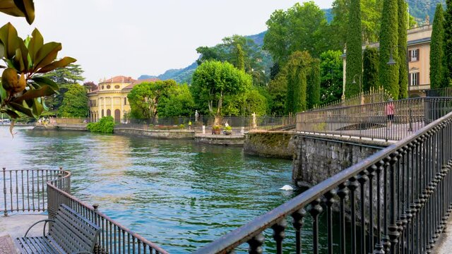 Romantic lakefront in Como harbour, tourist destination on Lake Como. The city contains numerous works of art, churches, gardens, museums, theatres, parks, and palaces RAW CINEMATIC