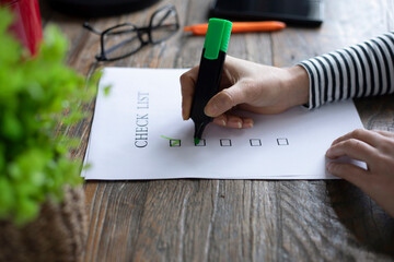 woman writing to check list