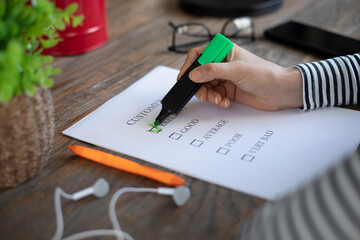 woman writing to check list