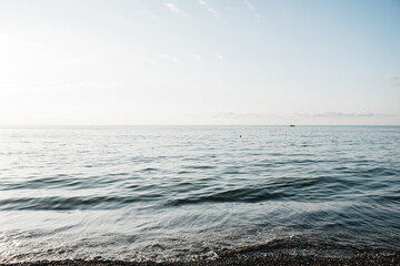 Beautiful white clouds on blue sky over calm sea ocean with sunlight reflection